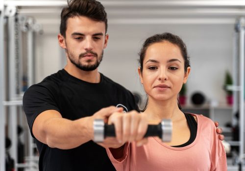 close-up-woman-exercising-with-dumbbell_23-2149178069
